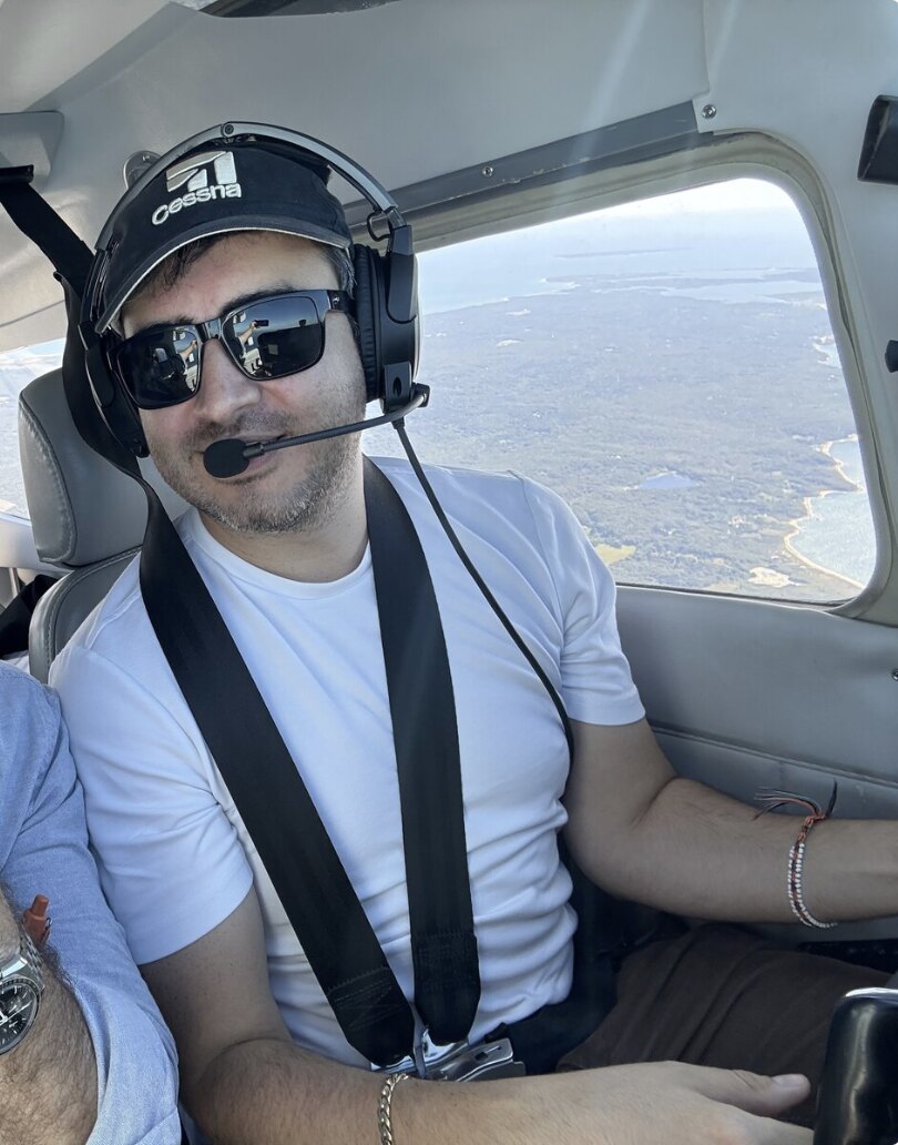 Simon Pacheco in the cockpit of a Cessna over the New England coast